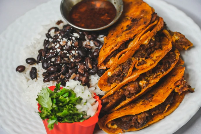 a white plate topped with tacos and rice